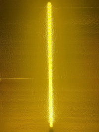 Yellow light beam on a textured yellow background