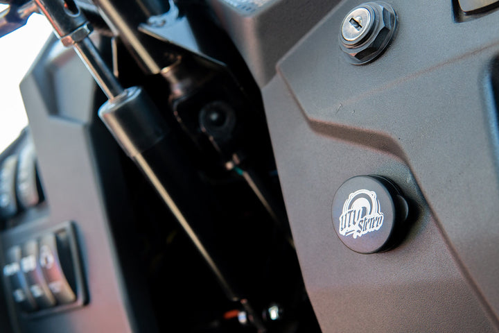 UTV Stereo branded plug installed on a vehicle dashboard