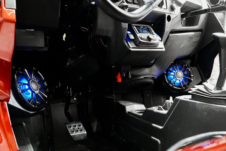 UTV Stereo audio system installed in vehicle dashboard with illuminated blue speakers