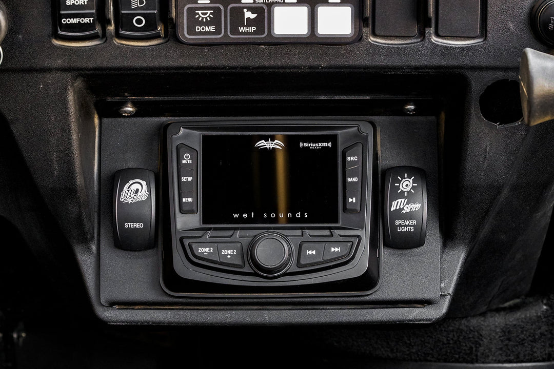 Wet Sounds digital media receiver mounted in a UTV dashboard with UTV Stereo rocker switches