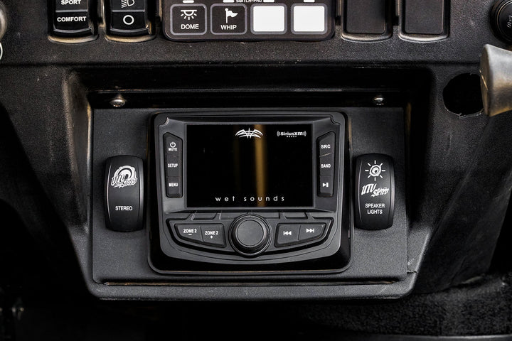 Wet Sounds digital media receiver mounted in a UTV dashboard with UTV Stereo rocker switches