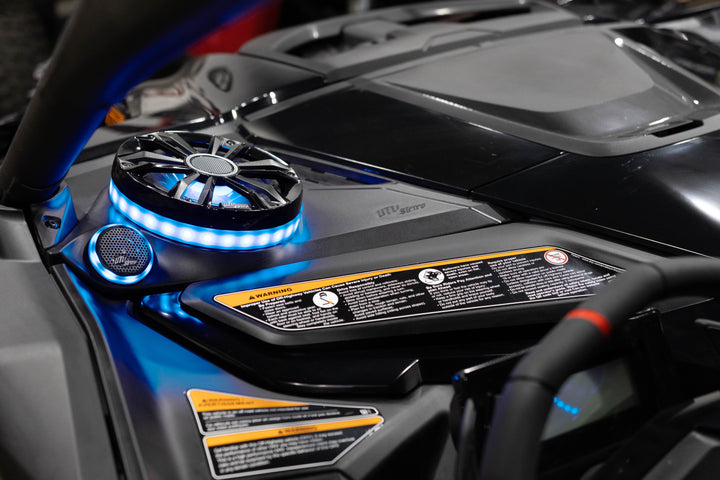 UTV Stereo speaker system with blue LED ring lighting installed in a vehicle dashboard