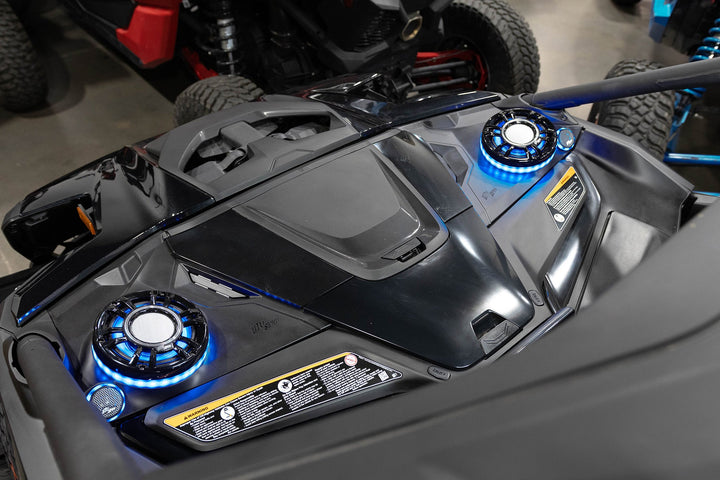 UTV Stereo speakers with blue LED rings installed in a vehicle dashboard