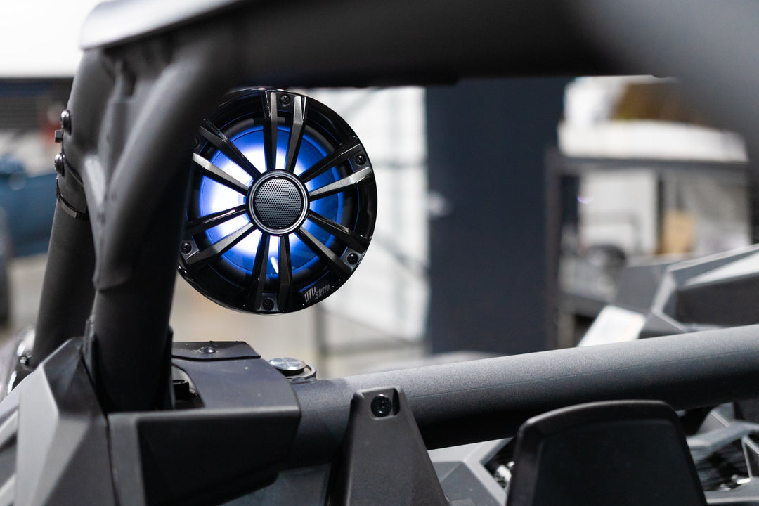 UTV Stereo speaker with blue LED lighting mounted on a roll cage