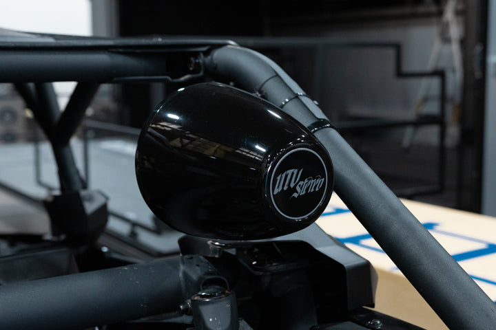 UTV Stereo black pod speaker mounted on a roll cage
