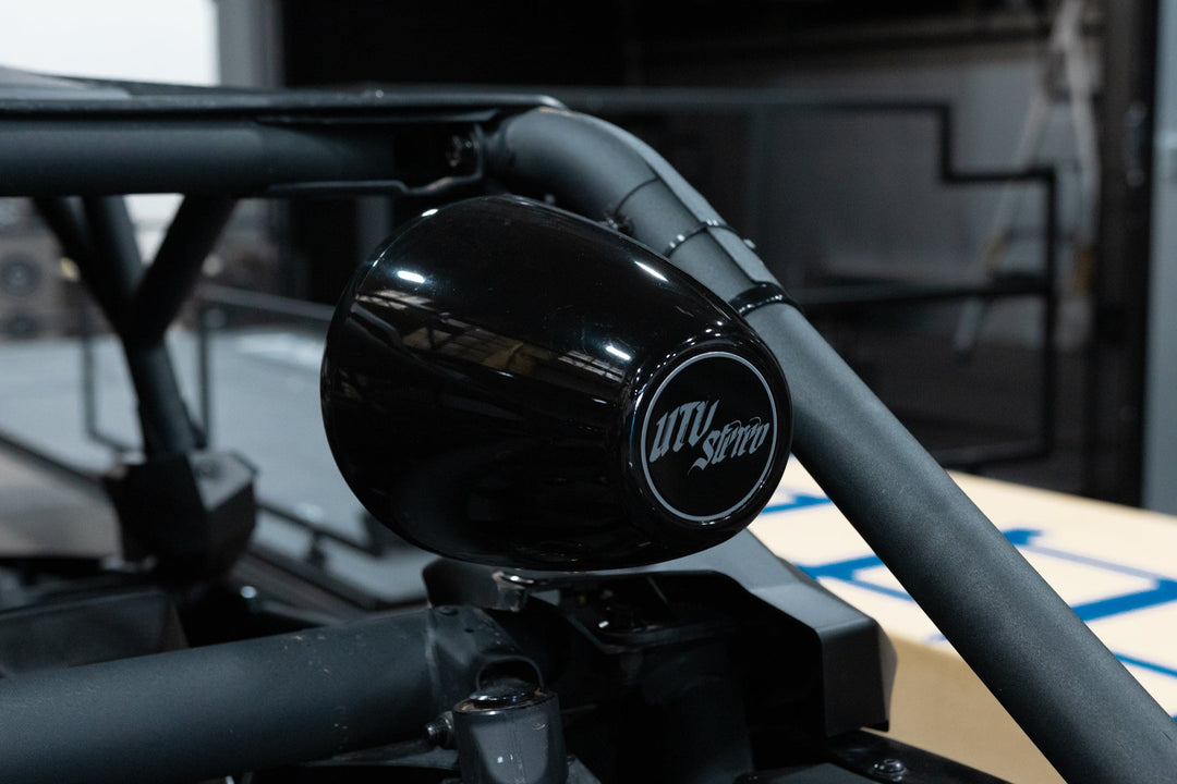 UTV Stereo black pod speaker mounted on a roll cage