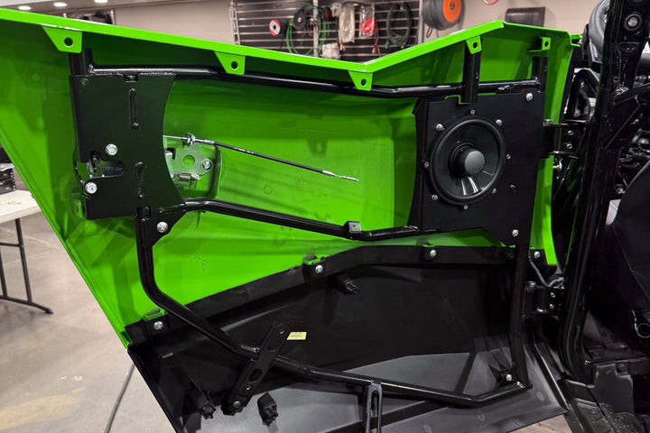 UTV Stereo speaker mounted in a green vehicle door panel