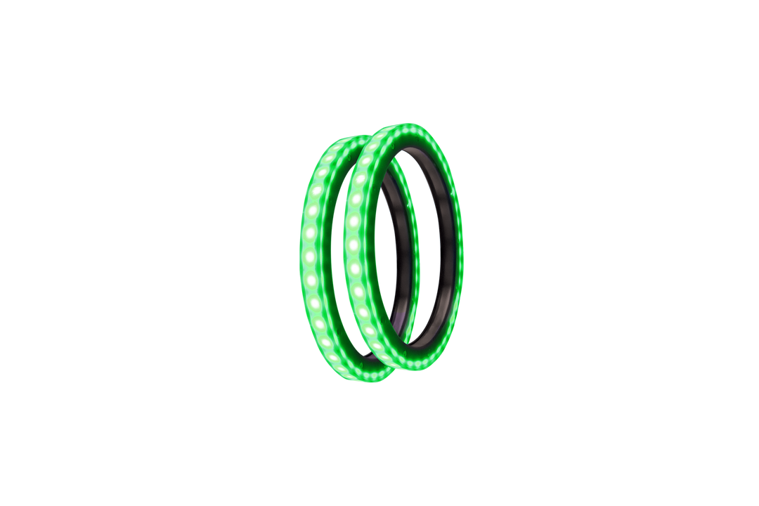 Two circular green LED light rings angled against a white background