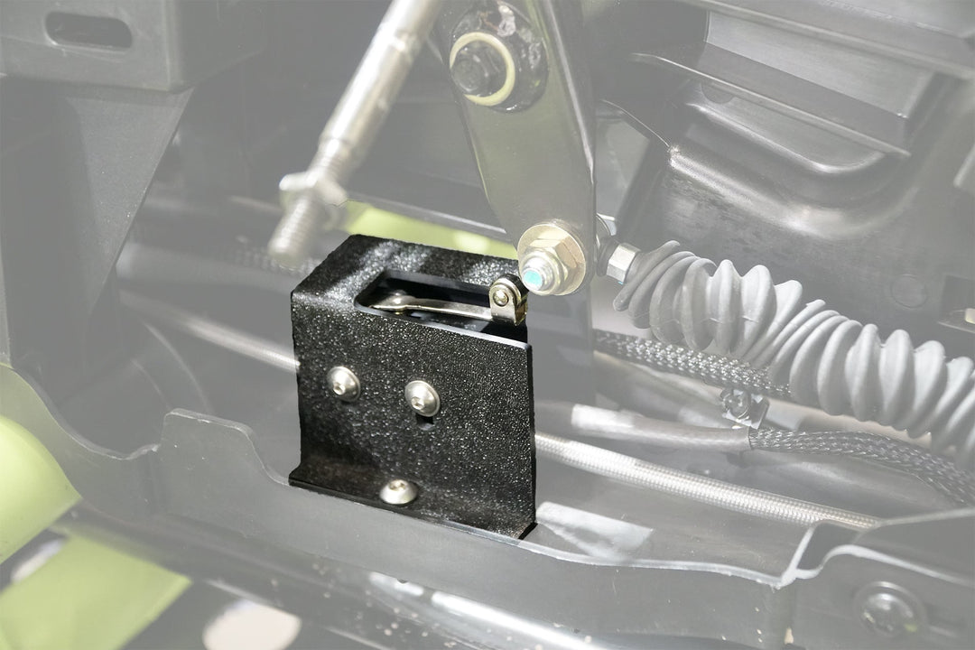 Black metal bracket installed on vehicle chassis with mechanical linkage