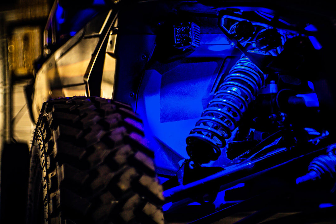 Close up of off road vehicle suspension with blue accent lighting