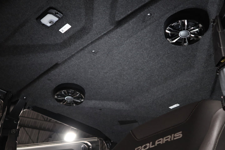 Polaris vehicle interior roof liner with integrated speakers and overhead light