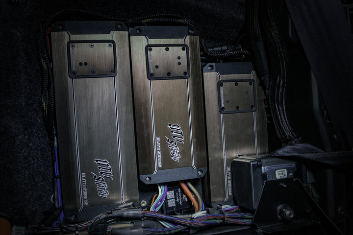 Three UTV Stereo Elite Series amplifiers mounted in a vehicle with connected wiring