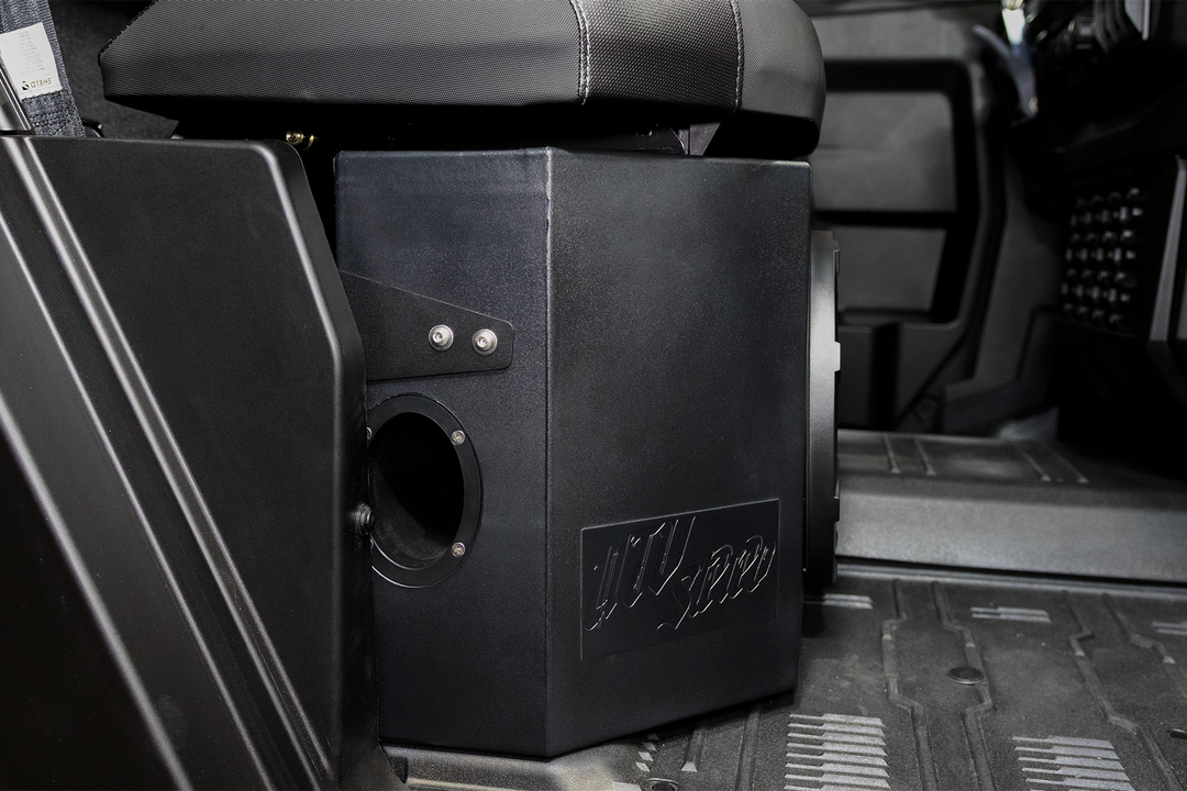 UTV Stereo black subwoofer enclosure installed under a vehicle seat