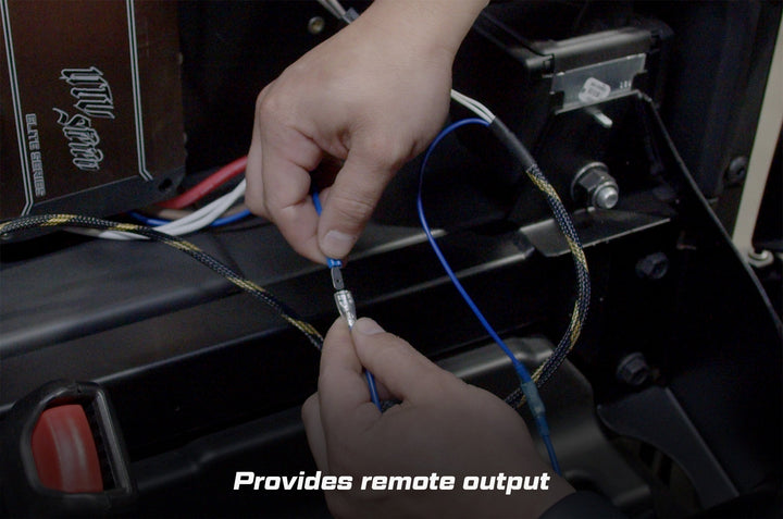 Hands connecting blue wire terminal for UTV Stereo remote output