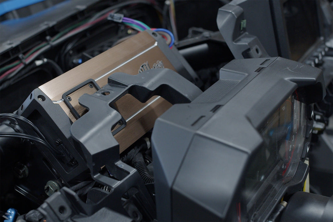 JL Audio amplifier installed behind vehicle dashboard