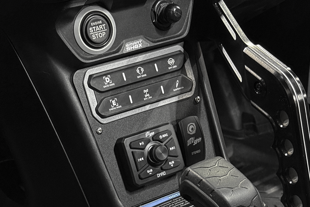 Can-Am vehicle dashboard with engine start button and UTV Stereo audio controls