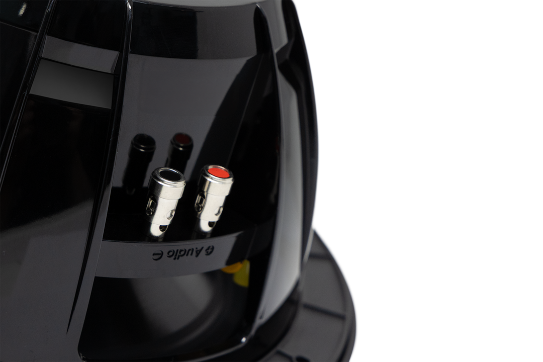 Rear view of a black subwoofer showing metal speaker wire terminals with red and black accents