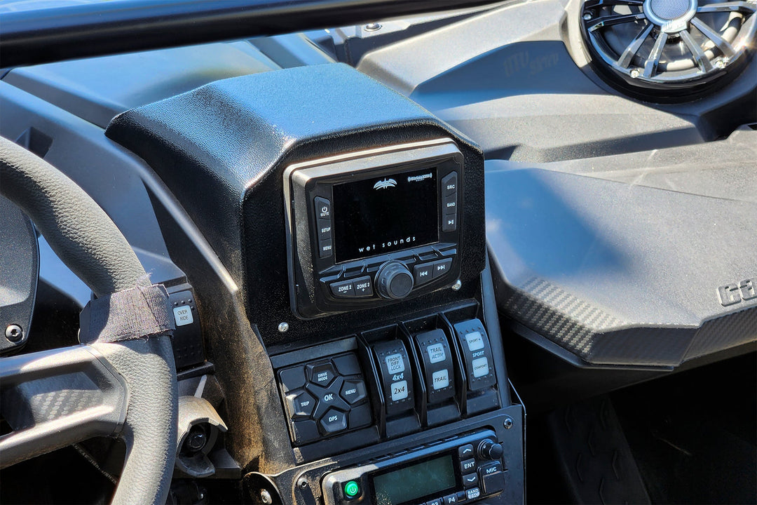Wet Sounds audio head unit mounted in a UTV dashboard with control switches