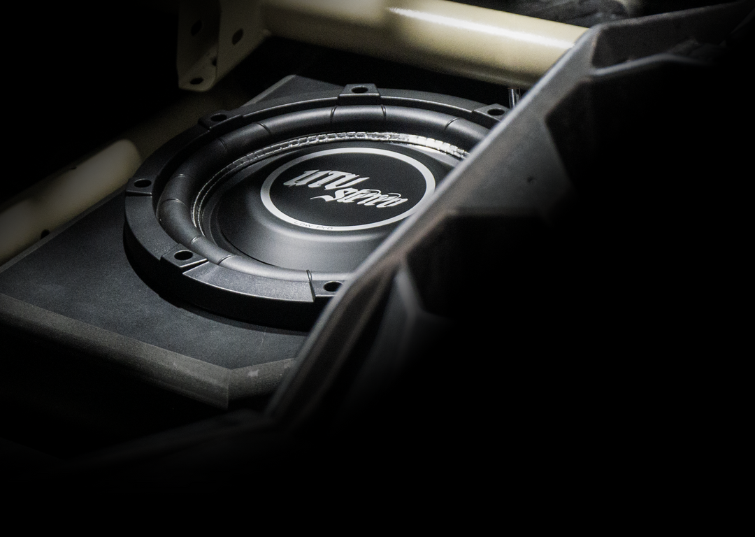 UTV Stereo subwoofer speaker mounted in a vehicle enclosure