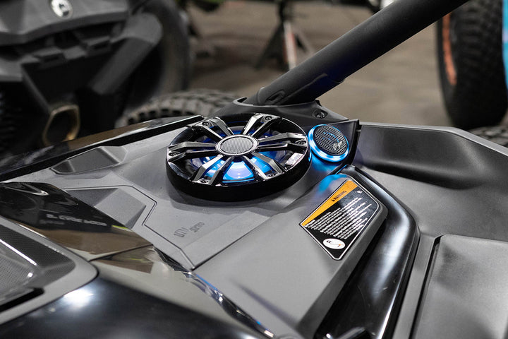 UTV Stereo speaker system with blue LED lighting installed in a vehicle dashboard