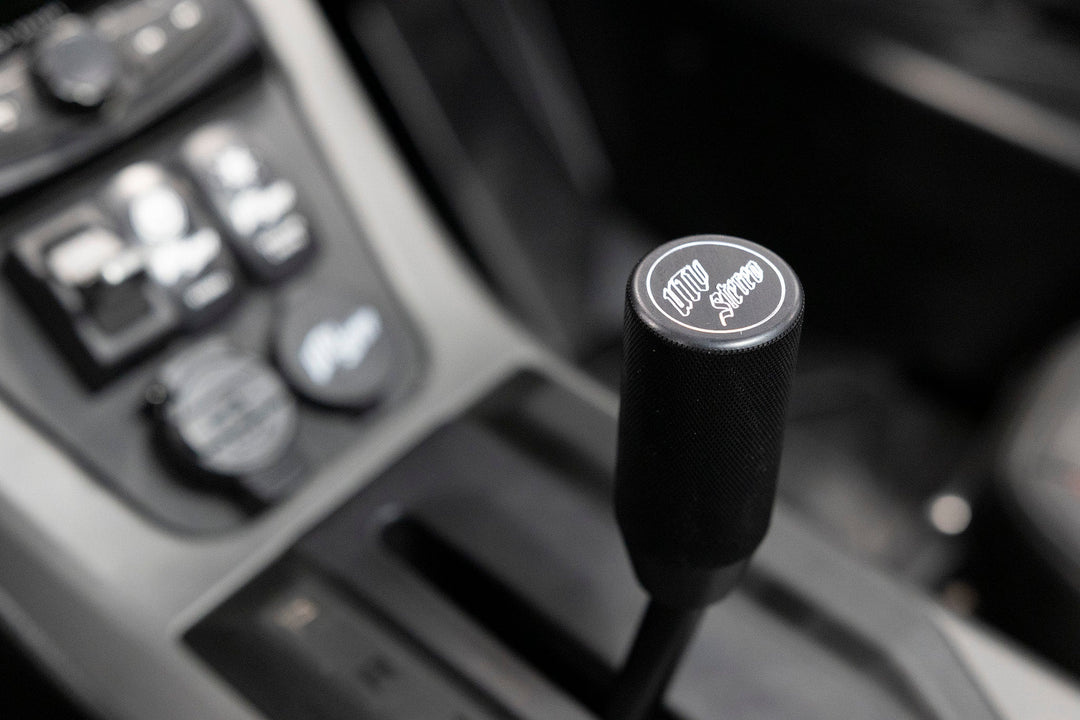 UTV Stereo branded black gear shift knob in vehicle interior
