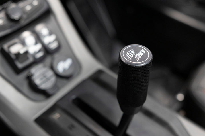 UTV Stereo branded black gear shift knob in vehicle interior