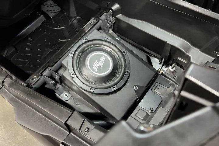 UTV Stereo subwoofer installed in a vehicle storage compartment