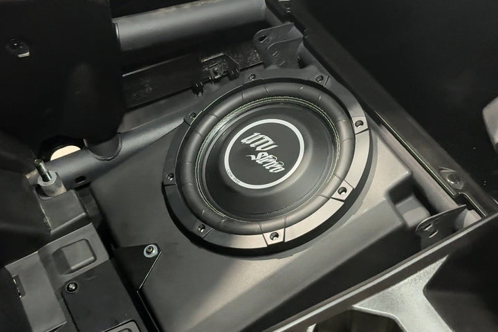 UTV Stereo subwoofer mounted in a black vehicle enclosure