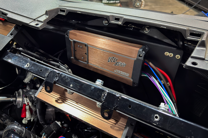 UTV Stereo Elite Series amplifier mounted inside vehicle dashboard