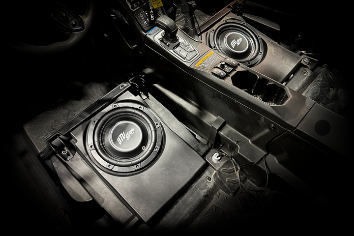 UTV Stereo subwoofer speakers installed in a vehicle center console