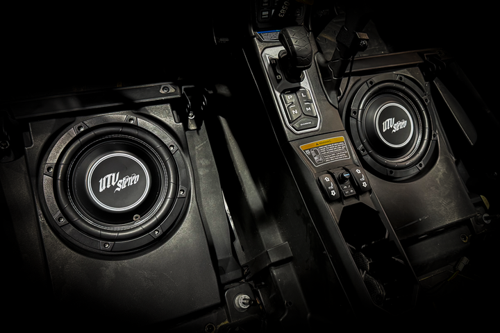 UTV Stereo subwoofer speakers installed in a vehicle center console