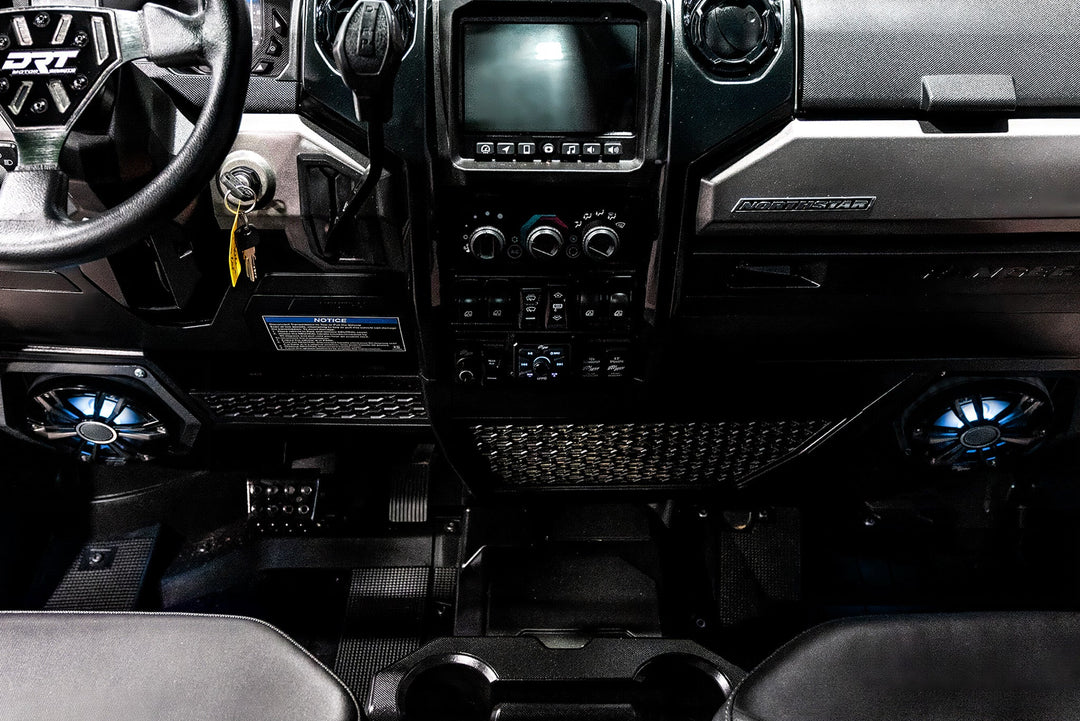 Interior dashboard of a Northstar vehicle with DRT steering wheel and illuminated blue speakers