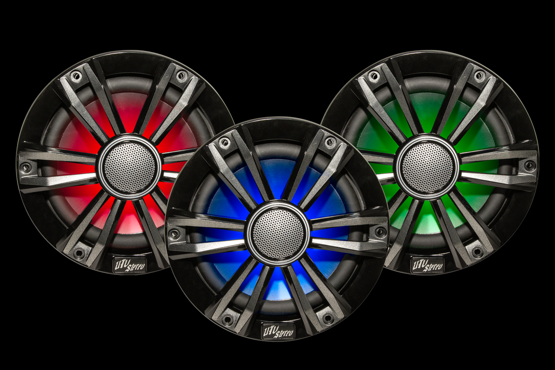 Three UTV Stereo speakers with red blue and green LED lighting on a black background