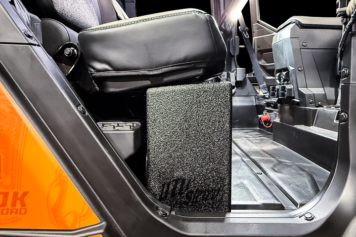 UTV Stereo subwoofer enclosure installed under the passenger seat of a side by side vehicle