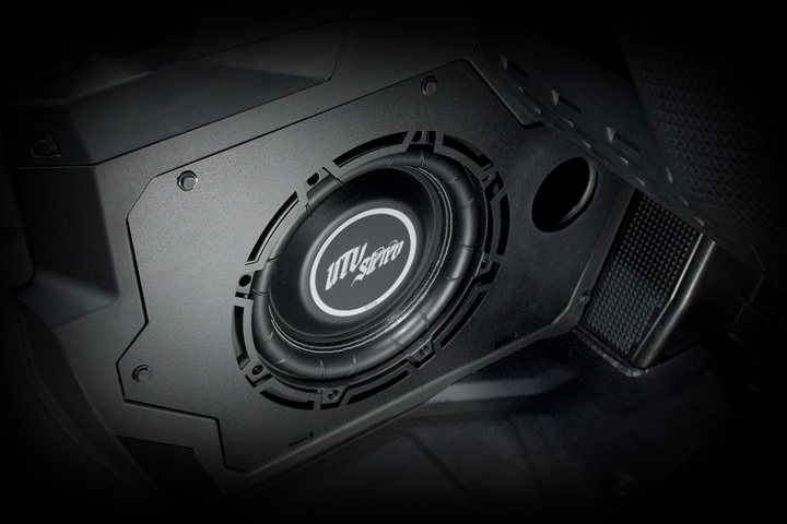 UTV Stereo subwoofer mounted in a black vehicle interior panel